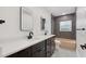 Modern bathroom featuring double sinks, mirrors, and tiled shower/tub at 3610 Pershing Ave, Orlando, FL 32812