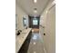 Stylish bathroom with dual sinks, decorative mirrors, modern fixtures and tiled shower at 3610 Pershing Ave, Orlando, FL 32812