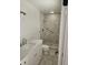 Bright bathroom featuring a tiled shower, grab bar and single sink vanity at 3610 Pershing Ave, Orlando, FL 32812