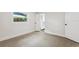 Bright bedroom with speckled flooring, closet, and window at 3610 Pershing Ave, Orlando, FL 32812
