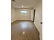 Bedroom with speckled concrete flooring, a window, and a white door at 3610 Pershing Ave, Orlando, FL 32812