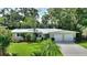 Charming single-story home with a well-manicured lawn, mature trees and a two-car garage at 3610 Pershing Ave, Orlando, FL 32812