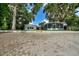Charming exterior view of a house with mature trees creating a serene and picturesque setting at 3610 Pershing Ave, Orlando, FL 32812