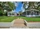 Charming home exterior with well-manicured lawn, mature trees, and a pathway leading to the entrance at 3610 Pershing Ave, Orlando, FL 32812