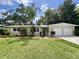 Charming single-story home with lush landscaping and a well-manicured lawn at 3610 Pershing Ave, Orlando, FL 32812