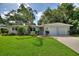 Charming single-story home boasts a well-manicured lawn, mature trees and a two-car garage at 3610 Pershing Ave, Orlando, FL 32812