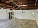Spacious garage featuring laundry hookups, a sink, utility closet, and painted concrete block walls at 3610 Pershing Ave, Orlando, FL 32812