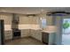 Modern kitchen features white cabinetry, stainless steel appliances, and quartz countertops at 3610 Pershing Ave, Orlando, FL 32812