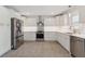 Bright kitchen featuring stainless steel appliances, white cabinets, and eye-catching backsplash at 3610 Pershing Ave, Orlando, FL 32812