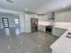 Open concept kitchen with stainless steel appliances and white cabinets at 3610 Pershing Ave, Orlando, FL 32812