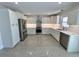 Bright kitchen featuring stainless steel appliances, white cabinetry, and modern countertops at 3610 Pershing Ave, Orlando, FL 32812
