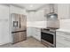 Corner view of kitchen featuring stainless steel appliances and bright white cabinets at 3610 Pershing Ave, Orlando, FL 32812