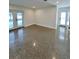 Bright living room with polished concrete flooring and french doors to the outside at 3610 Pershing Ave, Orlando, FL 32812