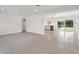 Open-concept living space with polished concrete floors seamlessly flowing into the kitchen at 3610 Pershing Ave, Orlando, FL 32812