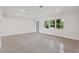 Bright living room with polished concrete floors and minimalist design with natural light at 3610 Pershing Ave, Orlando, FL 32812