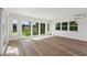 Well-lit open plan living room with wood floors and a view of the back yard at 3610 Pershing Ave, Orlando, FL 32812