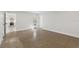 Bright, open-plan living room featuring polished floors and doorway to kitchen at 3610 Pershing Ave, Orlando, FL 32812