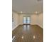 Bright living room with polished concrete floors and french doors to the backyard at 3610 Pershing Ave, Orlando, FL 32812