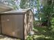 View of outdoor storage shed in the backyard with trees and lake at 3610 Pershing Ave, Orlando, FL 32812