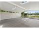 Large sunroom with skylights, ceiling fans and a screened-in view of the backyard and lake at 3610 Pershing Ave, Orlando, FL 32812