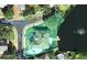 Aerial of a waterfront property, with lush green landscaping, private dock, and lake views at 5810 Lake Victoria Dr, Lakeland, FL 33813