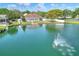 Stunning aerial view of a waterfront home featuring a large lake with fountain and private dock at 5810 Lake Victoria Dr, Lakeland, FL 33813