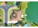 Aerial view of the home and dock on a lake with lush greenery at 5810 Lake Victoria Dr, Lakeland, FL 33813