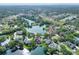 Lakefront home with lush surrounding greenery in an aerial view at 5810 Lake Victoria Dr, Lakeland, FL 33813