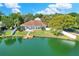 Aerial view of home, showcasing waterfront views, backyard, private dock, and mature trees at 5810 Lake Victoria Dr, Lakeland, FL 33813