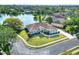 Stunning aerial view of home backing up to a tranquil pond with fountain and lush greenery at 5810 Lake Victoria Dr, Lakeland, FL 33813
