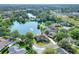 Breathtaking aerial view showcasing a waterfront home with lush landscaping and serene lake views at 5810 Lake Victoria Dr, Lakeland, FL 33813
