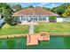 Aerial view showcasing the property's waterfront location and well-manicured yard with dock at 5810 Lake Victoria Dr, Lakeland, FL 33813