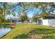 Lush backyard leading to a private lake and dock, plus a screened-in porch at 5810 Lake Victoria Dr, Lakeland, FL 33813