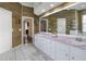 Bathroom featuring double sinks, white cabinets, and rustic wood accents at 5810 Lake Victoria Dr, Lakeland, FL 33813