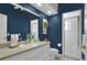 Stylish bathroom boasts a large mirror, white vanity, and a walk-in shower with glass door at 5810 Lake Victoria Dr, Lakeland, FL 33813