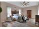 Inviting bedroom featuring rustic wood furniture, a ceiling fan, and warm natural lighting at 5810 Lake Victoria Dr, Lakeland, FL 33813