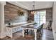 Charming dining room features wood panel accent wall, modern light fixture and views of the backyard at 5810 Lake Victoria Dr, Lakeland, FL 33813