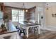 Dining room features stylish light fixture, wood panel accent wall, and natural light from backyard views at 5810 Lake Victoria Dr, Lakeland, FL 33813