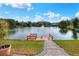 Dock with pavers leading to the home, plus a tranquil lake with fountain and mature landscaping at 5810 Lake Victoria Dr, Lakeland, FL 33813