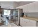 Spacious kitchen with stainless steel refrigerator, white cabinets, and view to the dining area at 5810 Lake Victoria Dr, Lakeland, FL 33813