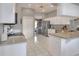 Bright kitchen with white cabinetry, stainless appliances, and a view into the adjacent dining room at 5810 Lake Victoria Dr, Lakeland, FL 33813