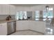 Well-lit kitchen features white cabinetry, stainless dishwasher, and granite countertops at 5810 Lake Victoria Dr, Lakeland, FL 33813