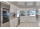 Bright kitchen features white cabinetry, stainless appliances, plenty of natural light, and a breakfast nook at 5810 Lake Victoria Dr, Lakeland, FL 33813