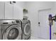 Laundry room with updated appliances, white cabinetry, and a functional layout for efficiency at 5810 Lake Victoria Dr, Lakeland, FL 33813
