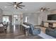 Open-concept living area with hardwood floors, a cozy sofa, and stylish furnishings at 5810 Lake Victoria Dr, Lakeland, FL 33813