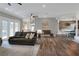 Spacious living room with wood floors, ceiling fan, modern furniture, and an open concept to kitchen at 5810 Lake Victoria Dr, Lakeland, FL 33813
