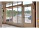 Bright sun room with tiled floor, large windows, and a view of the lake and fountain at 5810 Lake Victoria Dr, Lakeland, FL 33813