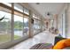 Enclosed sunroom features tile floors, many windows overlooking the pool, and lots of seating at 5810 Lake Victoria Dr, Lakeland, FL 33813
