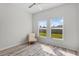 Bedroom with a chair and two windows that provide views of the grassy backyard at 3657 Daydream Pl, St Cloud, FL 34772
