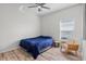 Cozy bedroom features wood-look floors and a comfortable seating area at 3657 Daydream Pl, St Cloud, FL 34772